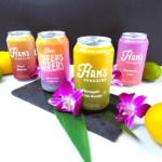 Four cans of hawaiian lemonade sitting on a table.